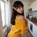 Young Woman with Elf Ears in Cozy Yellow Sweater