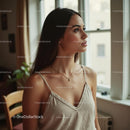 Young Woman in Thoughtful Pose by a Sunlit Window