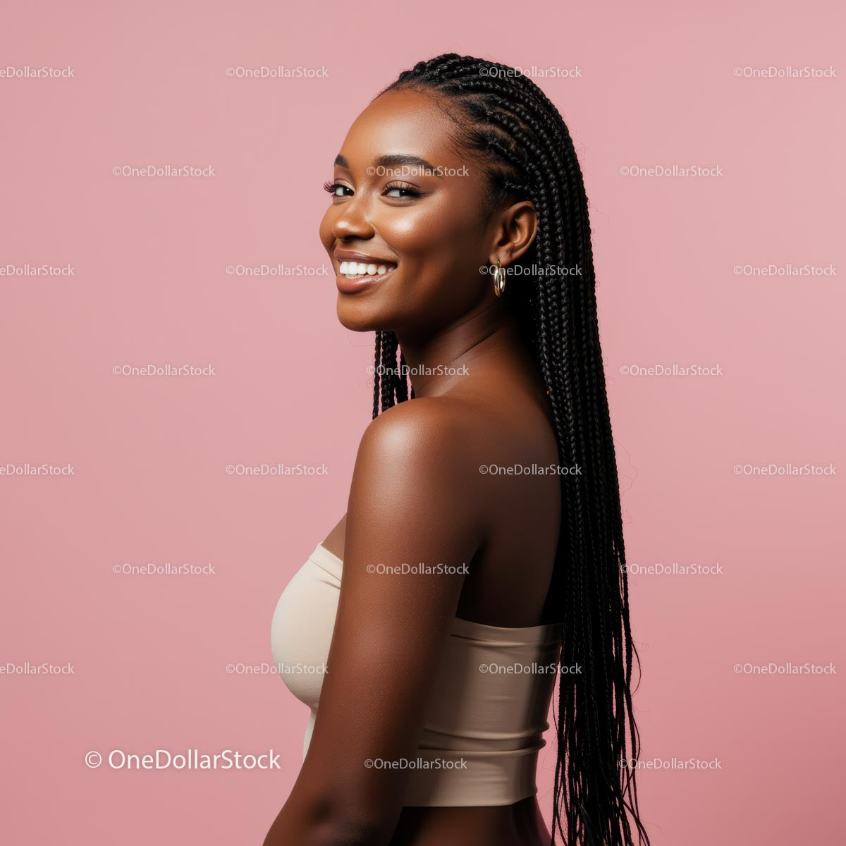 Smiling Woman with Braids Against a Pink Background