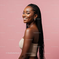 Smiling Woman with Braids Against a Pink Background