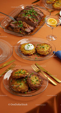 Gourmet Meal with Beef and Potato Pancakes on Orange Tablecloth
