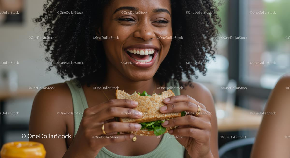 Smiling Woman Enjoying a Fresh Sandwich in Cafe Setting