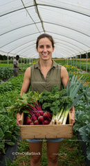 Smiling Farmer Holding Fresh Vegetables in Greenhouse