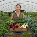 Smiling Woman with Fresh Vegetables in Greenhouse