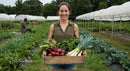 Smiling Woman with Freshly Harvested Organic Vegetables