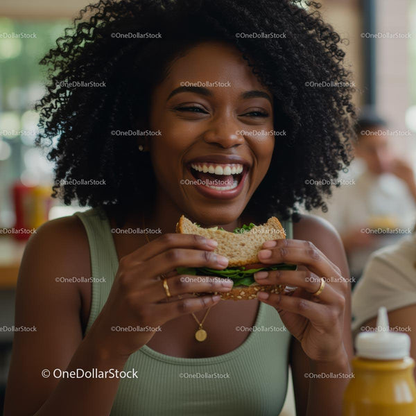Joyful Woman Enjoying a Sandwich in a Cafe