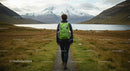 Explorer Hiking Towards Snow-Capped Mountains and Lake
