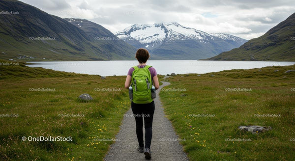 Woman Hiking with Green Backpack in Scenic Mountain Landscape