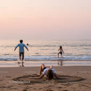 Relaxing on Beach at Sunset with Friends