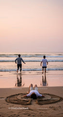 Two Men Running Towards Sunset on Sandy Beach