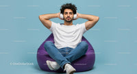 Relaxed Man Listening to Music on Purple Bean Bag