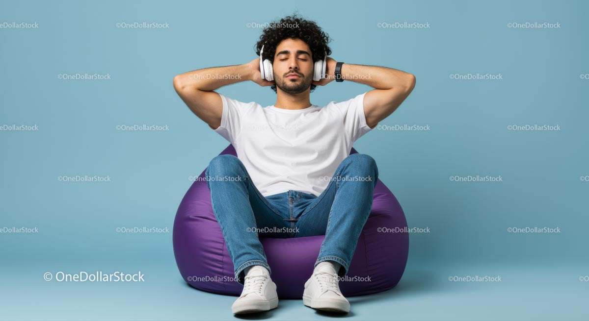 Young Man Relaxing on Purple Bean Bag with Headphones