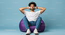 Young Man Relaxing on Purple Bean Bag with Headphones