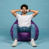 Man Relaxing on Purple Bean Bag with Headphones