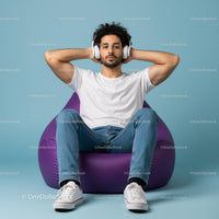 Young Man Relaxing with Headphones on Purple Bean Bag