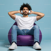 Young Man Relaxing with Headphones on a Purple Bean Bag