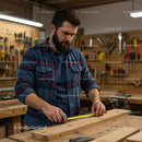 Skilled Carpenter Measuring Wood in Workshop