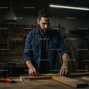 Skilled Carpenter Measuring Wood in a Workshop