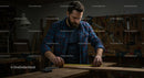 Focused Carpenter Measuring Wood in Busy Workshop