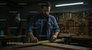 Carpenter Measuring Wood in Workshop with Precision