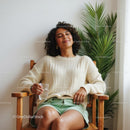Relaxed Woman in Cozy Setting with Indoor Plant