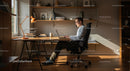 Man Working on Laptop in Sunlit Home Office