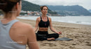 Women Practicing Yoga on a Serene Beachfront