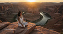 Silhouette of Woman Practicing Yoga at Scenic Canyon at Sunset