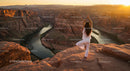 Silhouette of Woman Practicing Yoga at Scenic Canyon at Sunset