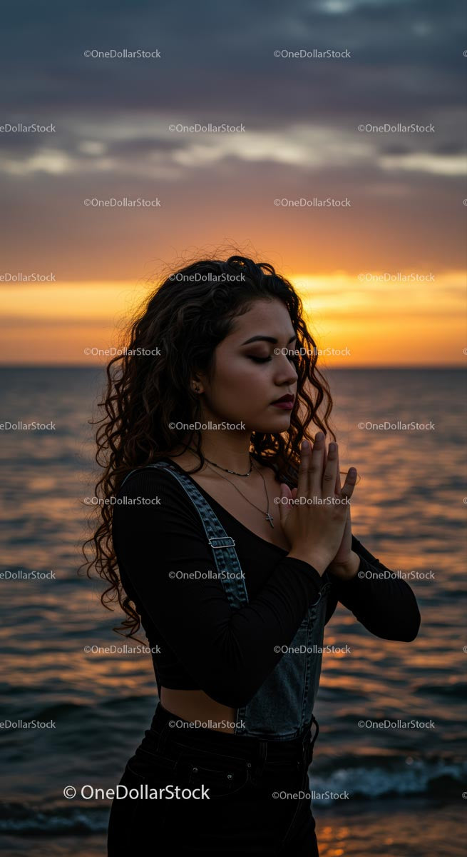 Woman Meditating by the Ocean at Sunset