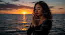 Woman Meditating Peacefully by the Ocean at Sunset