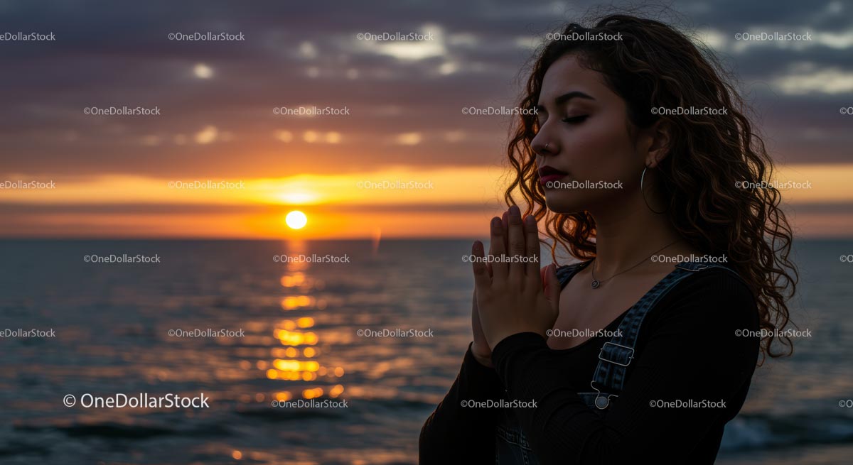 Woman Meditating at Sunset by the Ocean