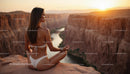 Woman Meditating at Sunset Over Majestic Canyon View