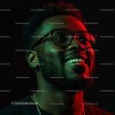 Joyful Man in Glasses with Vibrant Lighting