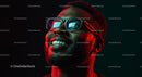 Smiling Man Wearing Glasses in Neon Red Light