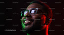 Smiling Man with Glasses in Colorful Lighting