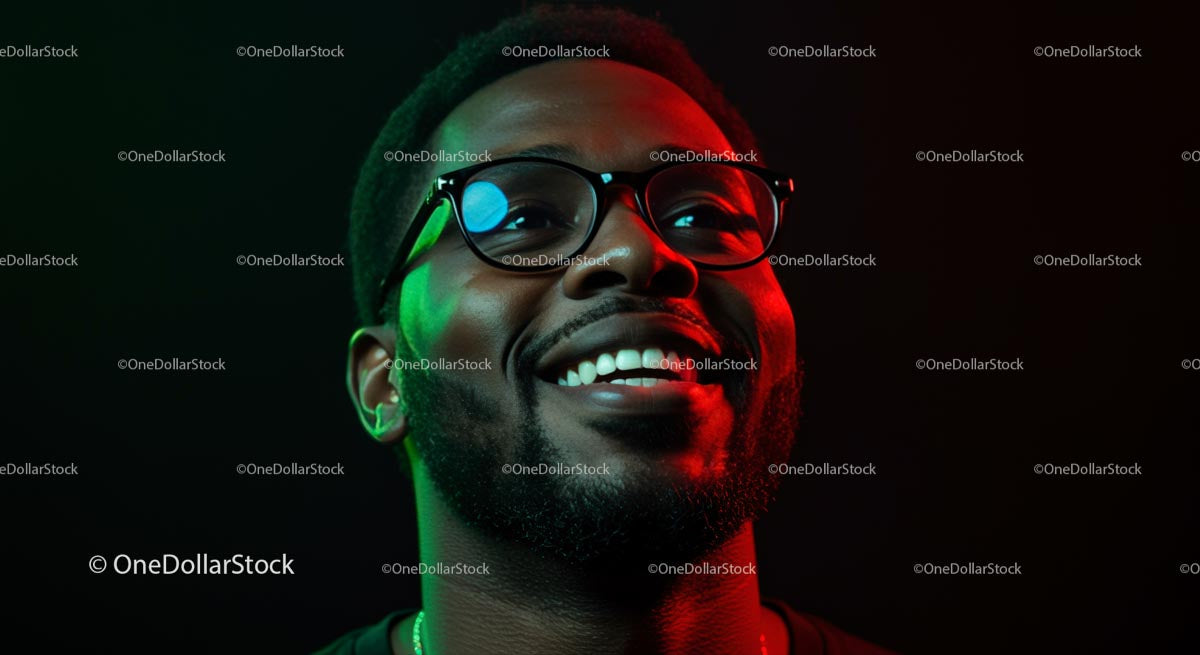Smiling Man in Glasses with Vibrant Red and Green Lighting