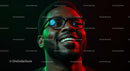 Smiling Man in Glasses with Vibrant Red and Green Lighting