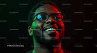 Smiling Man in Glasses with Vibrant Red and Green Lighting