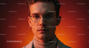 Stylish Young Man with Glasses in Warm Orange Lighting