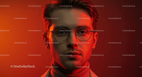Young Man with Eyeglasses Against Red Background