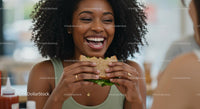 Joyful Woman Enjoying a Healthy Sandwich at Lunch