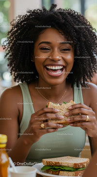 Smiling Woman Enjoying a Fresh Sandwich in Casual Setting