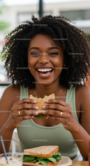 Joyful Woman Enjoying a Fresh Sandwich at Lunch
