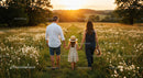 Family Walking Through Sunny Wildflower Field at Sunset
