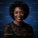 Smiling Woman in Black Lace Dress Against Blue Backdrop