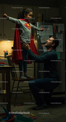 Father and Daughter Play in Superhero Costume at Home