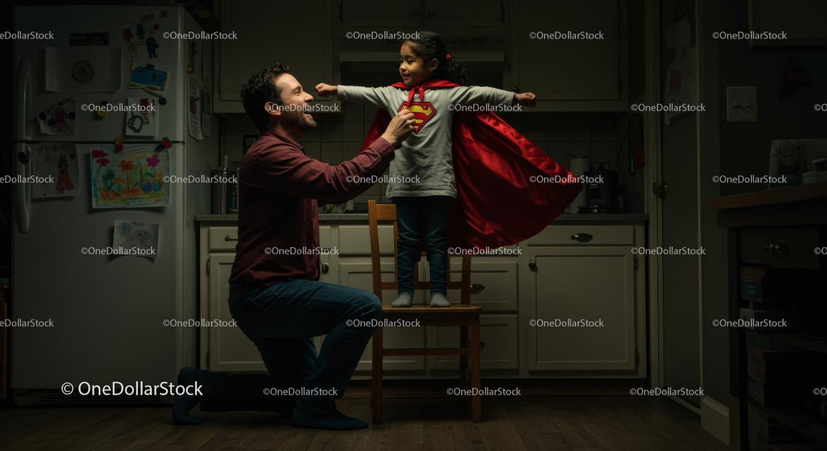Father and Daughter Play in Superhero Costume at Home
