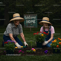 Mother and Daughter Planting Colorful Flowers in Backyard
