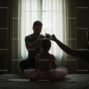 Father Styling Daughter's Hair for Ballet in Cozy Room